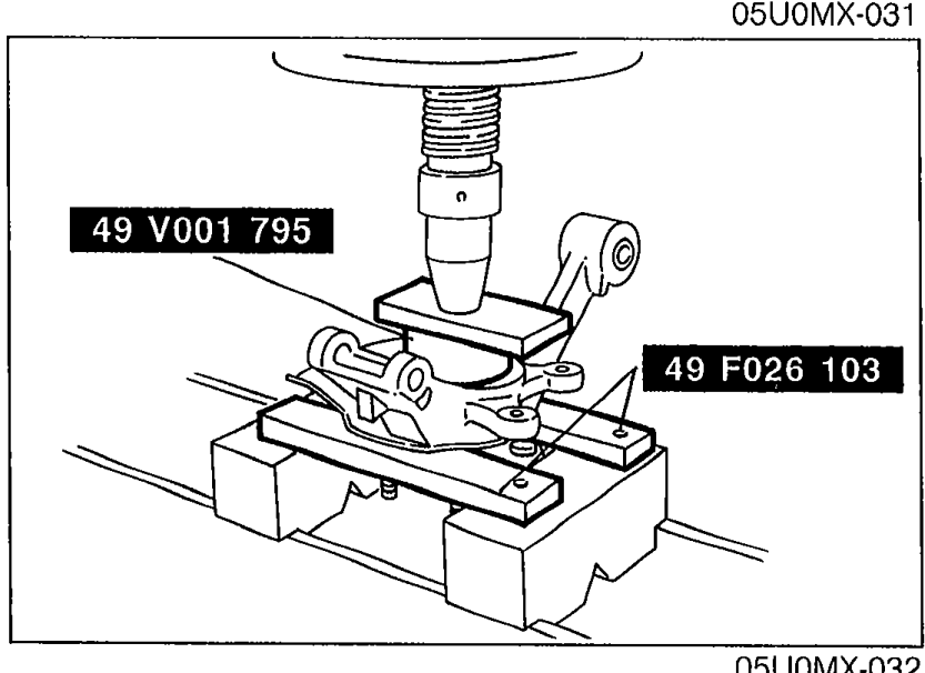 Photograph showing the new oil seal being installed with SSTs '49 V001 795' and '49 F026 103' on a press fixture.