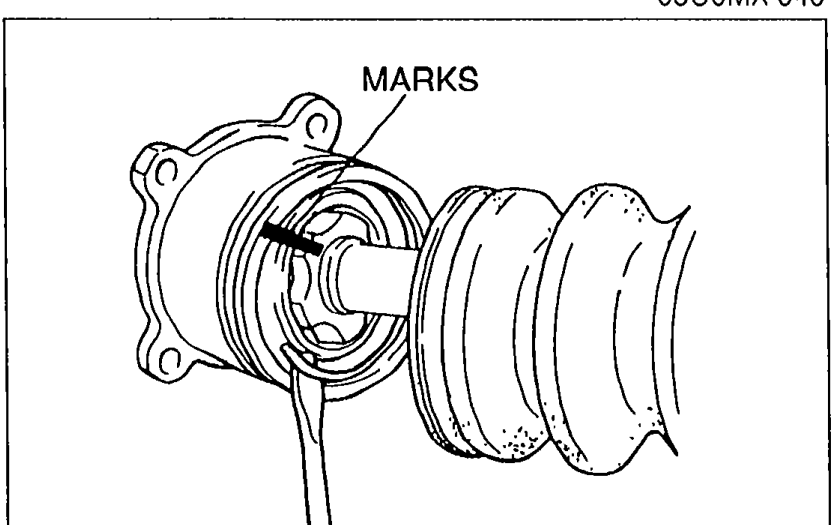 Driveshaft outer ring with paint MARKS indicated by an arrow, showing reference marks for proper reassembly alignment.