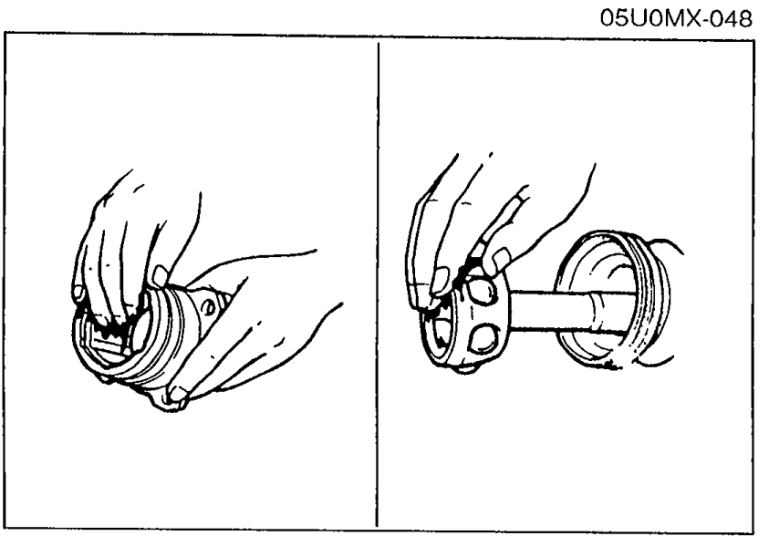 Two side-by-side close-up illustrations showing application of molybdenum disulfide grease to the joint/boot assembly.