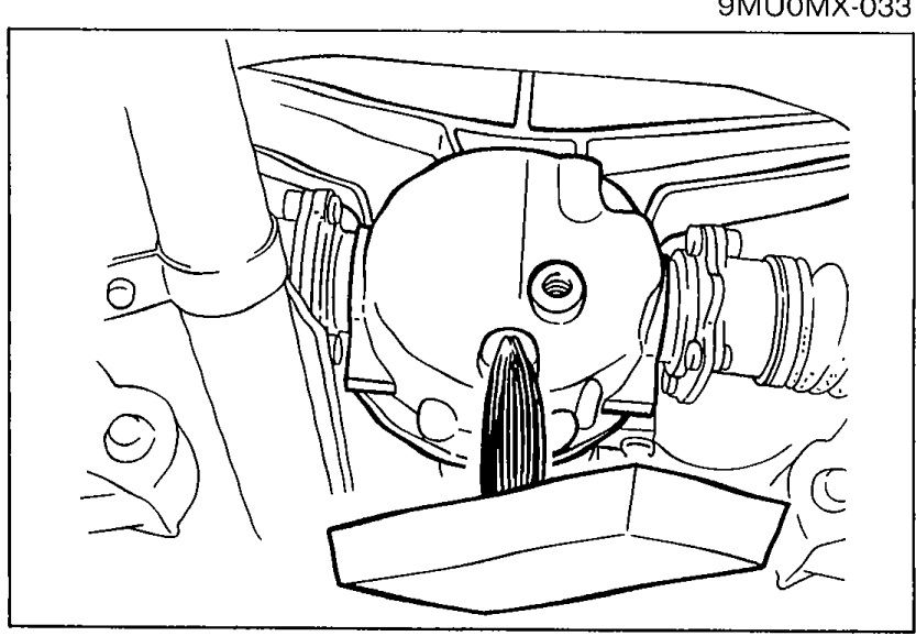 Under-vehicle view of the differential with a drain pan positioned beneath it, showing oil being drained from the drain plug.