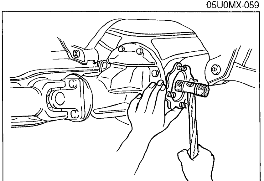 Hand installing the output shaft into the side gears by lightly tapping with a plastic hammer.