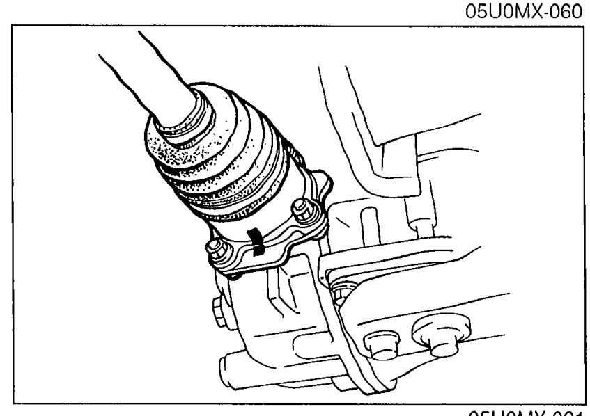 Driveshaft being aligned to the output shaft flange showing the alignment marks made earlier for proper reassembly.