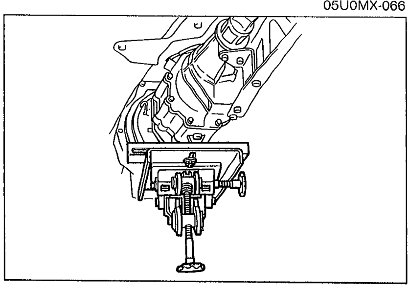 Under-vehicle view showing transmission supported with a jack and the PPF wire harness ready to be disconnected.