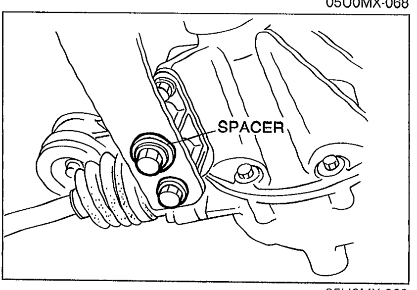 Differential-side bolts being removed with a SPACER callout indicating the spacer to be pried out.