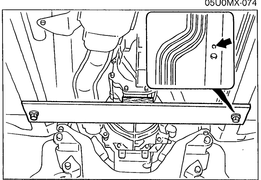 Photograph showing the steel plate installed underneath the transmission area, supporting it from below the fire wall area. Arrows point to the installation location.