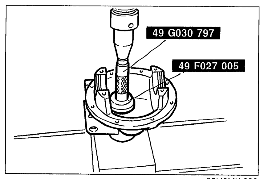 Illustration showing SST 49 G030 797 with SST 49 F027 005 being used to install the bearing outer race (rear bearing) into the differential carrier.