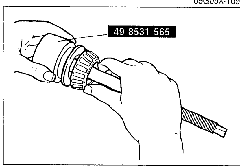 Illustration showing the spacer and bearing inner race (rear bearing) being installed onto SST 49 8531 565 by hand.