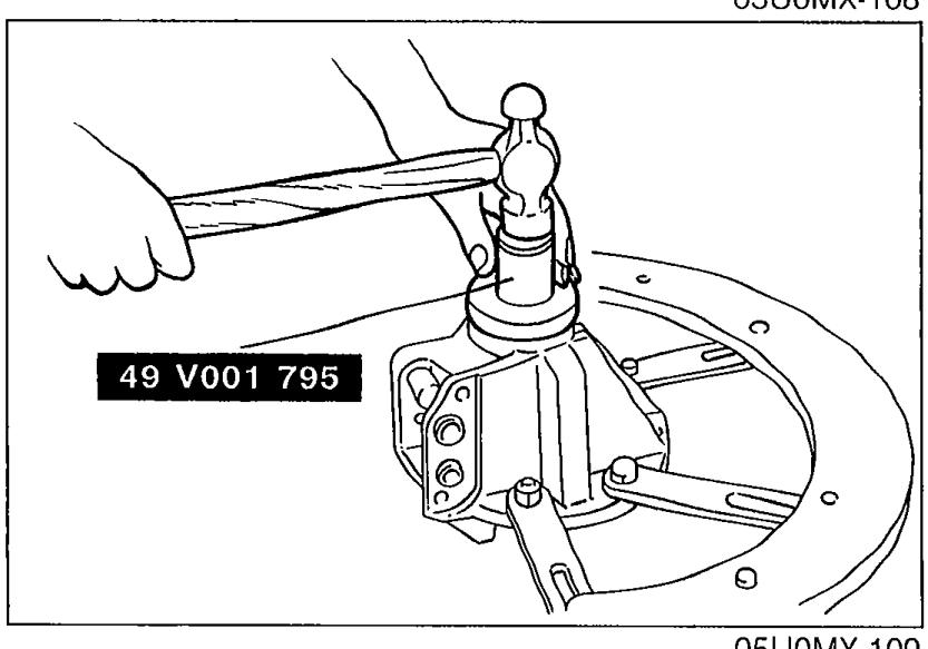 Photo showing SST 49 V001 795 being used to tap a new oil seal into the differential carrier.