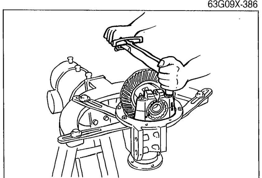 Photo showing a torque wrench being used to tighten the bearing cap bolts on the differential carrier.