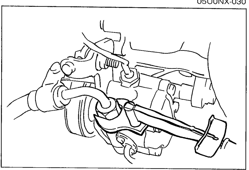 Underside view showing steering gear housing with high-pressure hose connection point and wrench positioned for the tightening torque.
