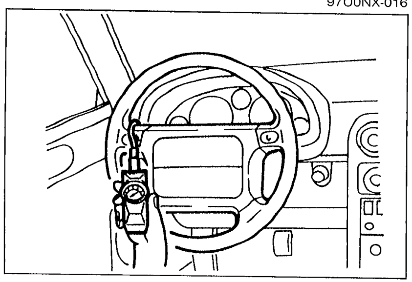 Interior view showing pull scale attached to the outermost point of the steering wheel spoke to measure steering wheel effort.
