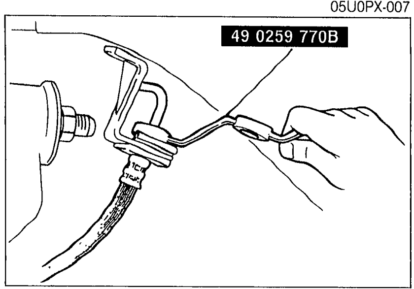 Special service tool 49 0259 770B (flare nut wrench) being used to loosen the flare nut on a brake line at a flexible hose connection.