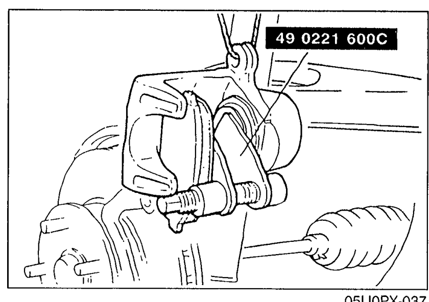 Illustration of the front brake caliper with SST 49 0221 600C (piston pusher / C-clamp style) installed across the caliper to push the piston inward in preparation for new pad installation.
