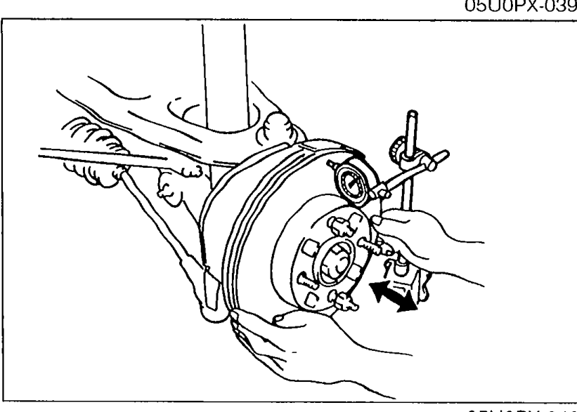 Illustration of measuring disc plate (rotor) runout with a dial indicator mounted on the suspension/knuckle, with the probe contacting the outer edge of the disc plate surface.
