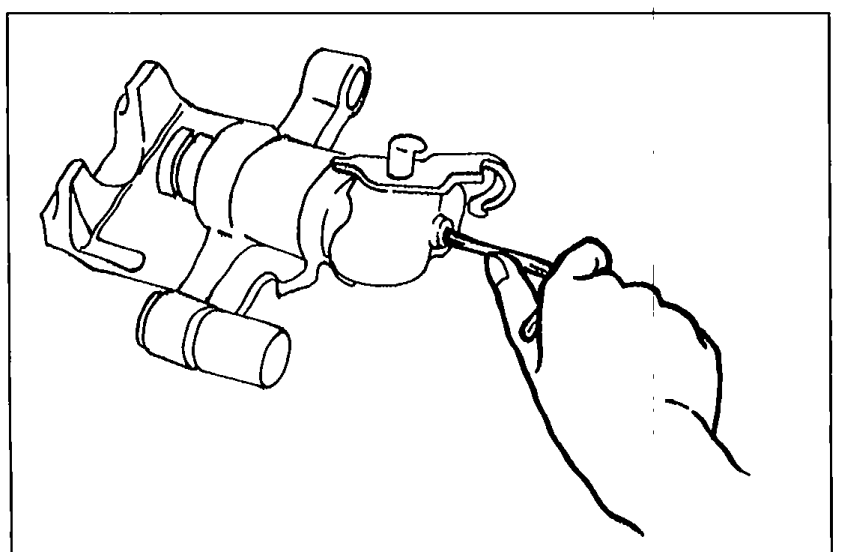 Illustration showing a hand using an Allen wrench to turn the adjustment gear clockwise to remove the piston from the caliper.