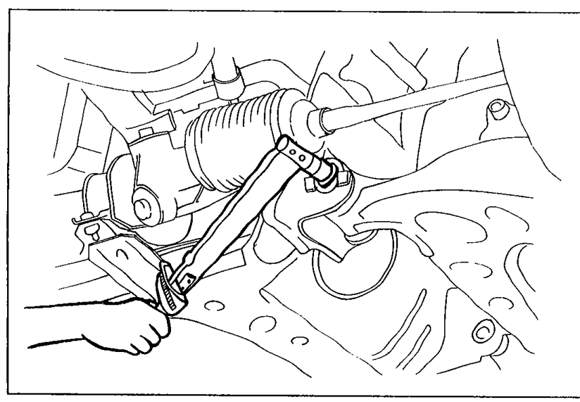 Photo showing a wrench being used to tighten the front lower-arm cam nut after camber/caster adjustment.