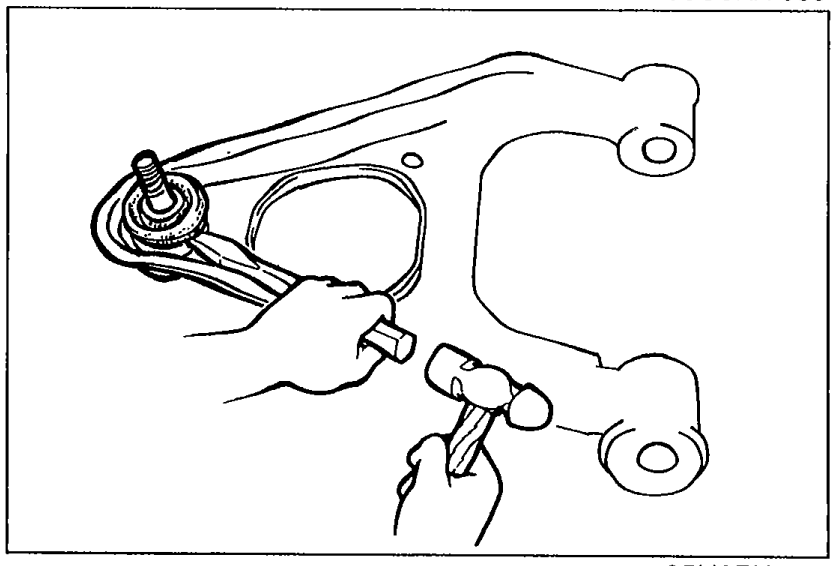Chisel being used to remove the ball joint dust boot from the upper arm ball joint.