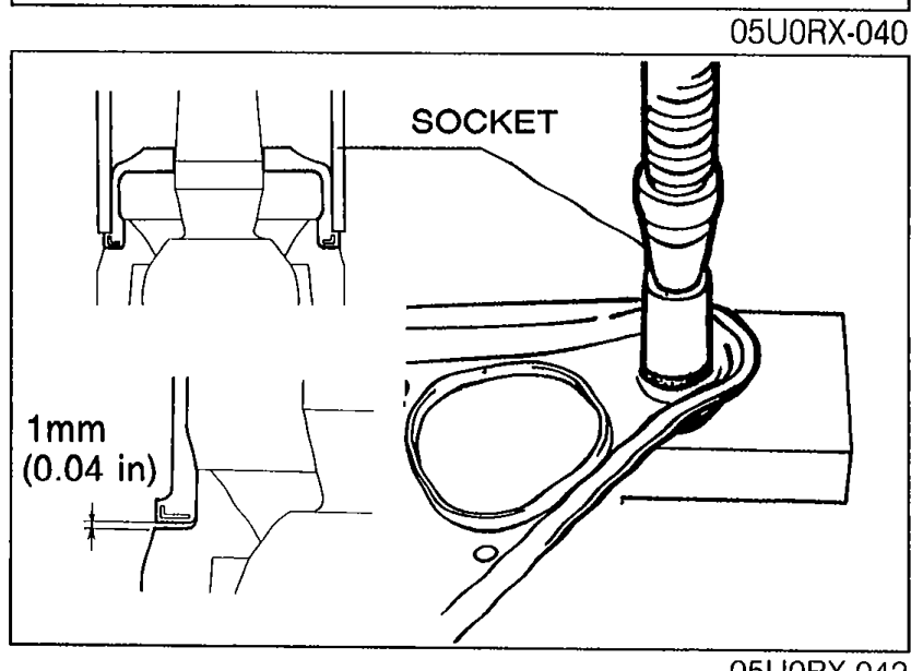 30mm (1 1/8 in) socket pressing dust boot onto upper arm ball joint. Shows '1mm (0.04 in)' clearance dimension between boot and seat.