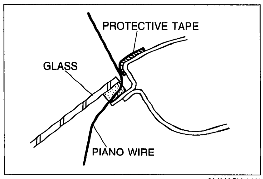 Cross-section detail of the windshield edge showing PROTECTIVE TAPE applied to the body, the GLASS, and a PIANO WIRE passed through the sealant bead. Illustrates step 1 of the removal note.