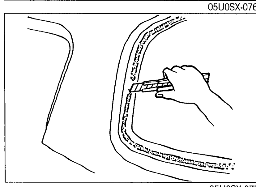 Hands using a razor knife to cut away old sealant around the rear-window aperture of the hard top, leaving a 1 to 2 mm (0.04 to 0.08 in) thick layer. Illustrates installation step 1.