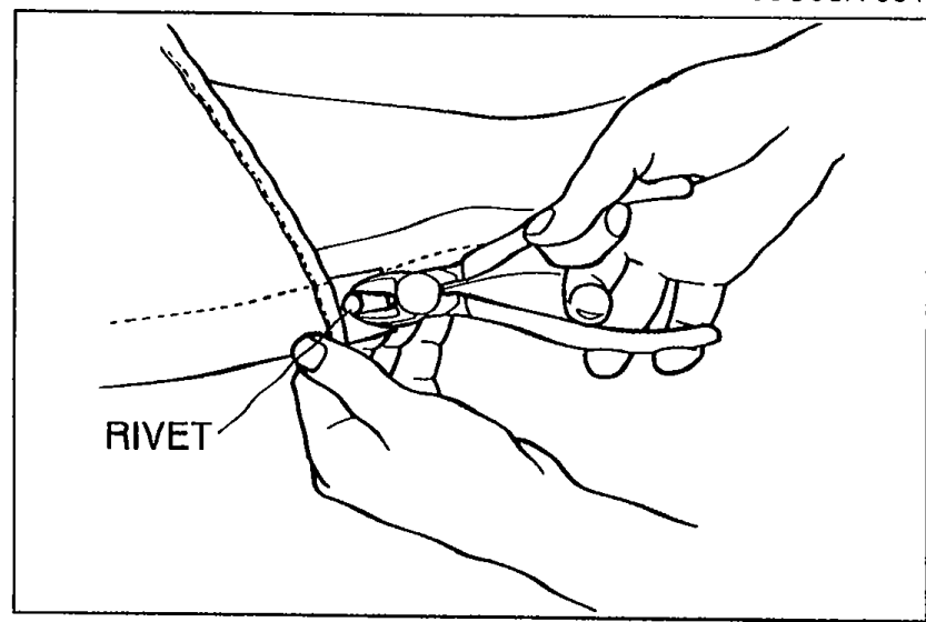 Cutter being used to remove rivets from the rear window edge. Label: RIVET.
