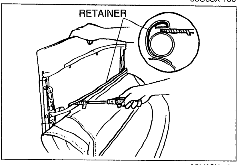 Rear bow area showing the RETAINER being pried back with a protected screwdriver; Velcro and top fabric are visible.