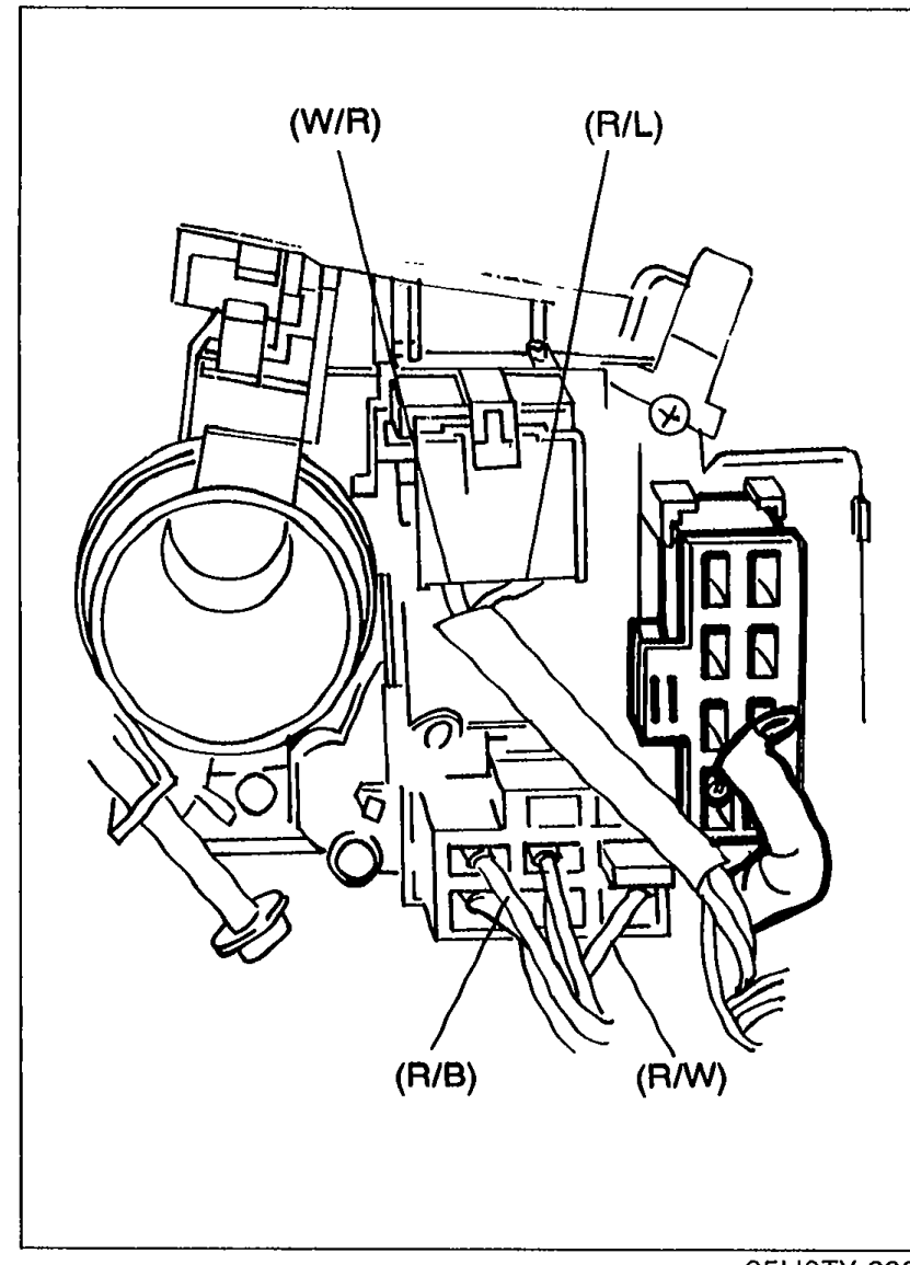 Photo of the combination switch on the steering column with the column cover removed, showing the headlight switch connectors labeled with terminal-wires (W/R), (R/L), (R/B) and (R/W) at the connector openings.