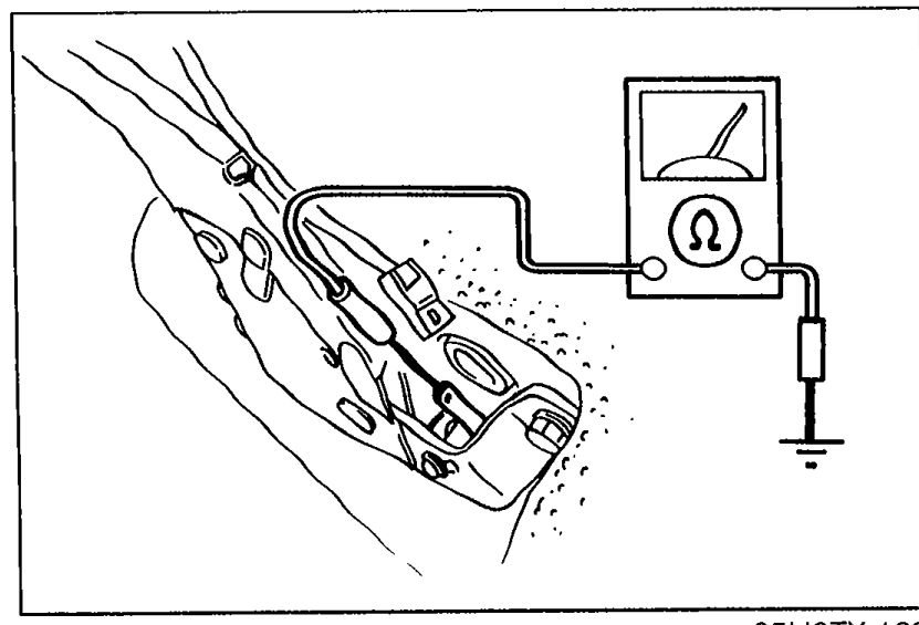 Parking brake assembly with the parking-brake switch connector disconnected; an ohmmeter test lead is being attached to the switch terminal and a body ground for the continuity check.