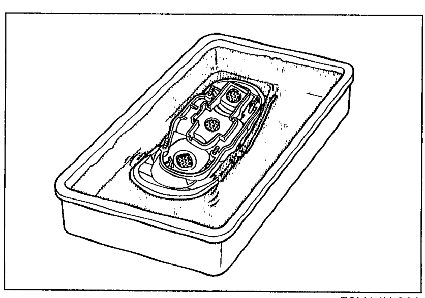 Rear combination light assembly submerged in a tub of water as part of the leak-check procedure (Step 6).