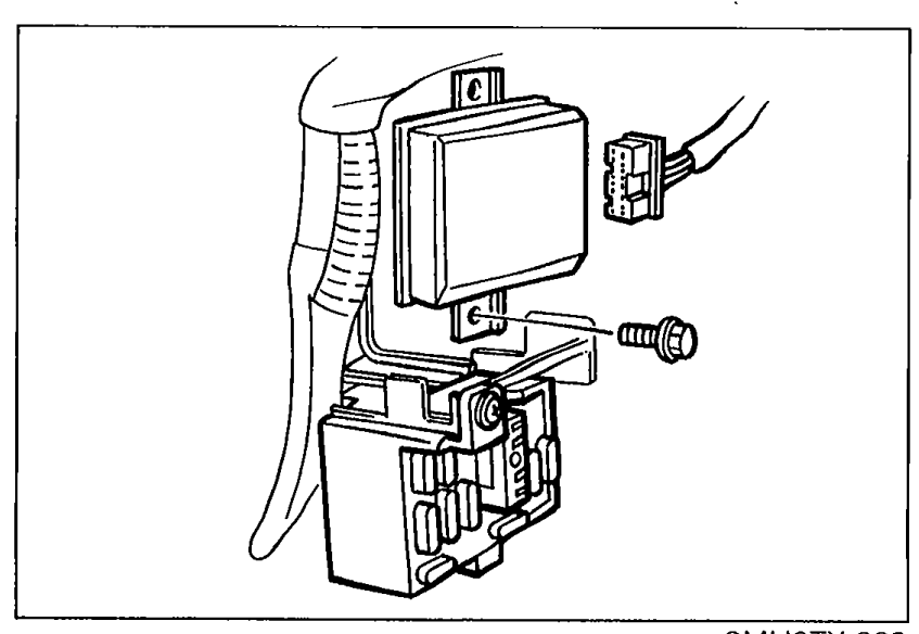 Installed cruise control unit behind the passenger side kick panel, secured by a nut, with the connector still attached.