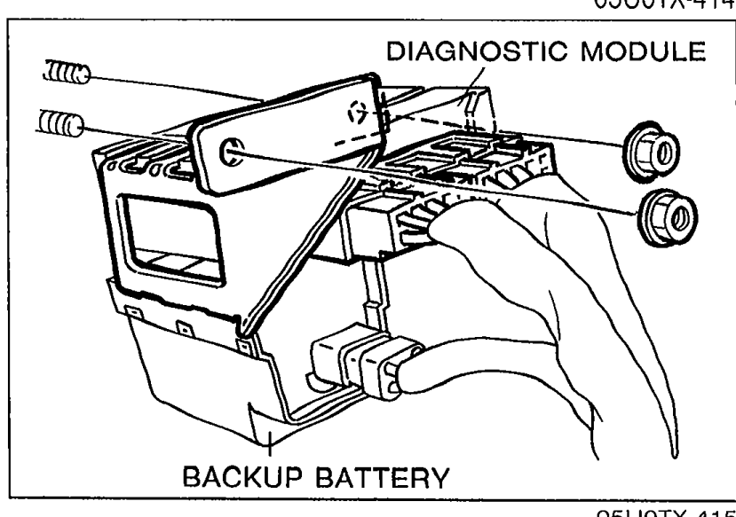 View of the diagnostic module and backup battery assembly mounted in the vehicle, with labels 'DIAGNOSTIC MODULE' and 'BACKUP BATTERY' identifying the components.