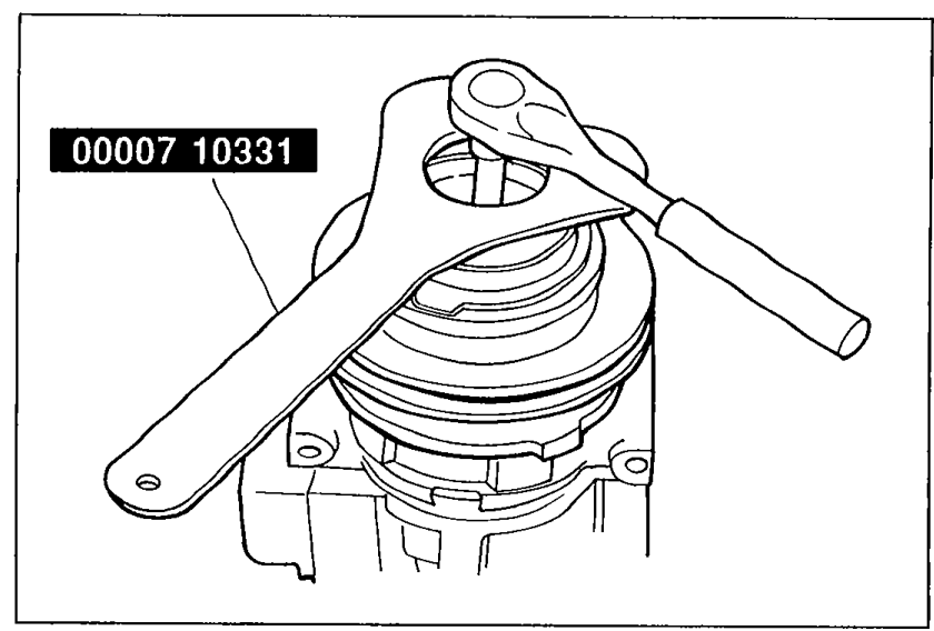 Technician using SST (special service tool) 00007 10331 wrench to hold the magnetic clutch assembly while another wrench removes the central shaft nut.